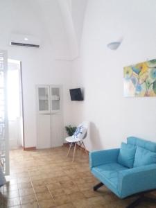 a living room with a blue couch and a table at M & G - Casa Vacanze in Santa Maria al Bagno