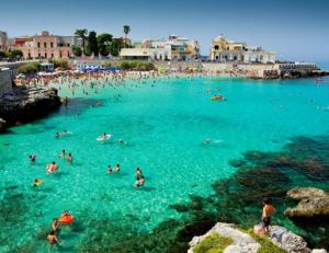 a group of people in the water at a beach at M & G - Casa Vacanze in Santa Maria al Bagno