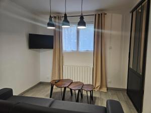 a living room with two chairs and a couch at L appartement du Clos Loret - Alençon in Saint-Germain-du-Corbéis