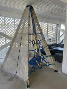 a tent is being erected in a living room at Gulf Shores Haven Pools Tent Tiki Bar Games Pool Table Early Checkin in Gulf Shores