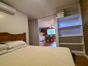 a bedroom with a bed and a open refrigerator at Flat 305 hotel Fazenda Engenho Pedra do Rodeadouro in Bonito +31 photos