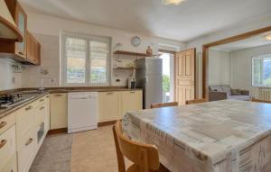 a large kitchen with a large wooden table with chairs at Casa L'uliveto in Moneglia