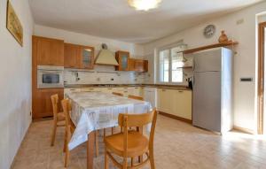 a kitchen with a table and chairs and a refrigerator at Casa L'uliveto in Moneglia +12 photos