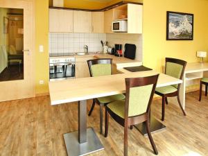 a kitchen with a wooden table and chairs at Apartment by Lake Plau with Stunning Views in Plau am See