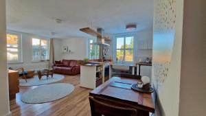 a kitchen and living room with a couch and a table at Gronocottage in Bad Harzburg