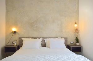 a bedroom with a white bed with two night stands at Room with a view 105 in Rome