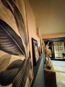 a bedroom with a large peacock feather on the wall at Suite Richovilare - Sauna & Hammam in Riquewihr +32 photos