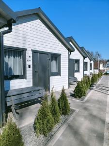 a row of houses with christmas trees in front of them at Domki Letniskowe Sarbilove in Sarbinowo