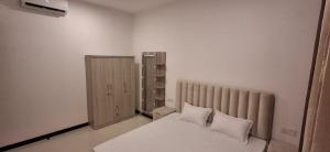 a bedroom with a bed with white sheets and pillows at The Anchorage Grand Colombo AT TRI-ZEN COLOMBO 02 in Colombo +24 photos