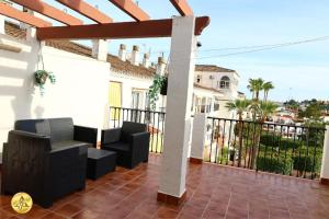 a patio with black chairs on a white house at Mijas Room A4J in Mijas