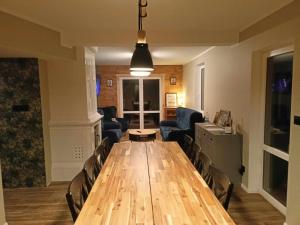 a living room with a long wooden table and chairs at Agroturystyka W ogrodzie babci Ani in Kościeniewicze +13 photos
