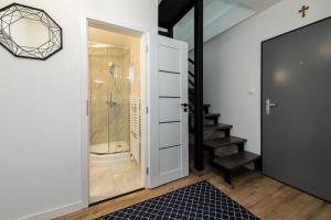 a bathroom with a walk in shower and a glass door at ALAVIA Residence in Veľká Lomnica +64 photos