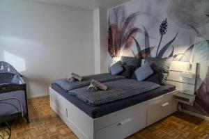 a bedroom with a bed with a mural on the wall at Ferienhaus Dorfmark in Bad Fallingbostel