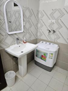 a bathroom with a sink and a toilet and a mirror at Welcome Ten 5km far from Masjid Nabawi in Al Madinah