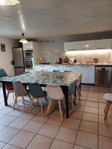 a kitchen with a large table with chairs around it at Gîte les Granges dans ferme provençale. 14 pers in Ongles