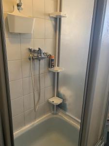 a bathroom with a shower and a bath tub at Kleine Wohnung in Overath in Overath +8 photos