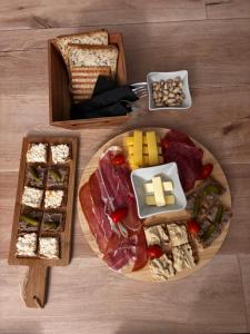 a table with a plate of food with cheese and bread at L'Ecrin secret in Aire-sur-la-Lys +25 photos
