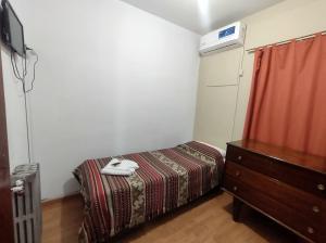 a bedroom with a bed and a dresser and a television at Hotel Viñas San Rafael in San Rafael +6 photos