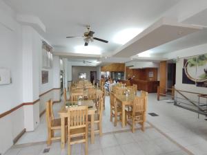 a dining room with wooden tables and chairs at Hotel Viñas San Rafael in San Rafael