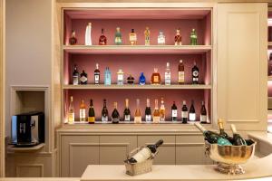 a liquor cabinet filled with lots of bottles of wine at Hotel Residence Foch in Paris