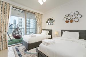 Krevet ili kreveti u jedinici u okviru objekta King 2BR With Burj Khalifa View In Boulevard Point