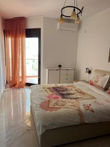 a bedroom with a bed with a painting on it at Modern Seaview Apartment with a Pool in Dobra Voda +23 photos