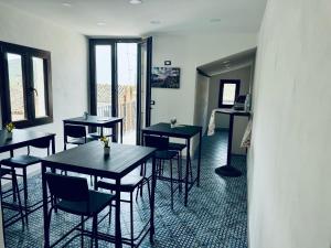 a restaurant with tables and chairs in a room at Corleone Home casa vacanze in Corleone
