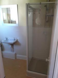 a bathroom with a shower and a sink at Seawall, 30A Burlington Road in Swanage +19 photos