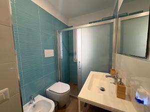 a bathroom with a sink and a toilet and a shower at La Casa di Nonna Maria in SantʼAmbrogio +18 photos