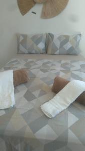 a bed with two towels and pillows on it at Excelente Flat no alto de Bezerros in Bezerros