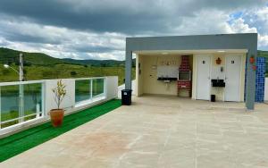 a house with a large patio with green grass at Excelente Flat no alto de Bezerros in Bezerros