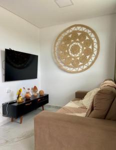 a living room with a couch and a window at Excelente Flat no alto de Bezerros in Bezerros