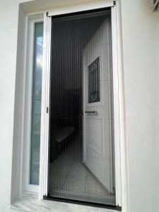 a glass door leading into a room with a toilet at Sufiko Studios - Drosia in Armenistis