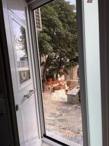 an open door with a view of a yard at Sufiko Studios - Drosia in Armenistis +8 photos