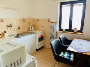 a small kitchen with a sink and a table at Chata Domeček in Liberec
