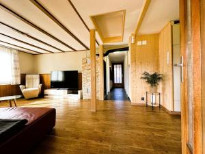 a living room with a couch and a television at Time out near Lake of Thun & Emmental region in Fahrni
