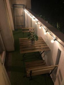 a bench with a potted plant on a balcony with lights at Le St Aubin appartement Hypercentre de Toulouse in Toulouse