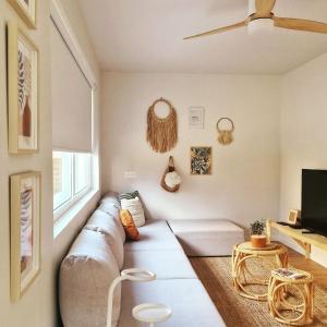 a living room with a couch and a tv at La Maison des Petits Bonheurs in Rixheim