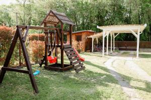 a playground with a slide and a gazebo at Horgony Szállás in Békésszentandrás