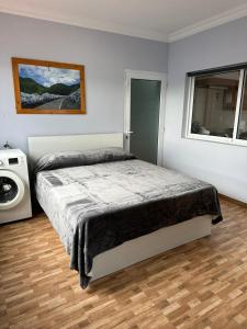 a bedroom with a bed and a window at Santa Barbara Beach hotspot in Ribeira Grande