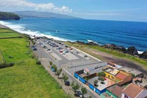 an aerial view of a parking lot next to the ocean at Santa Barbara Beach hotspot in Ribeira Grande