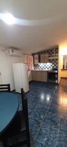 a kitchen with a blue table and a kitchen with cabinets at Puñadito de Descanso B in Salta