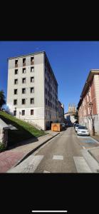 a building on the side of a street with a car at AtuaireHome Cabestreros a un paso de la catedral y el Castillo in Burgos