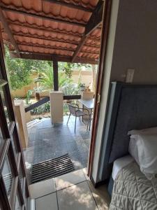 a room with a bed and a patio with a table at Constantia Manor Guest House in Pretoria +229 photos