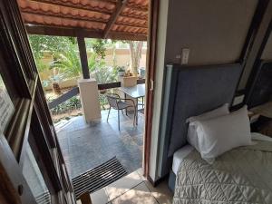 a bedroom with a bed and a balcony with a table at Constantia Manor Guest House in Pretoria