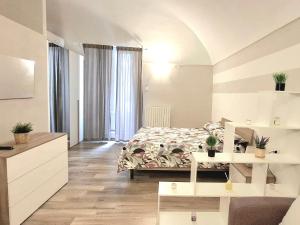 a bedroom with a bed in a room with windows at Abruzzo Holiday in Ortona