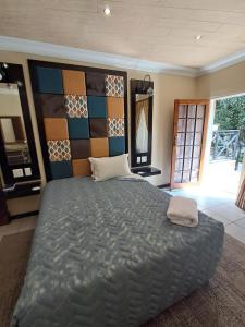 a bedroom with a large bed with a large wall at Constantia Manor Guest House in Pretoria