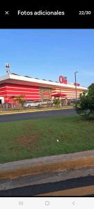 a fast food restaurant with a red building at Ciudad Juan Bosch in La Cana