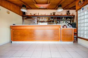 a kitchen with a wooden bar in a restaurant at Bed and Breakfast della Palma in Gela
