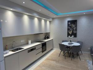a kitchen with a table and a sink and a counter at Belgrade Waterfront Penthouse 17th last floor in Belgrade